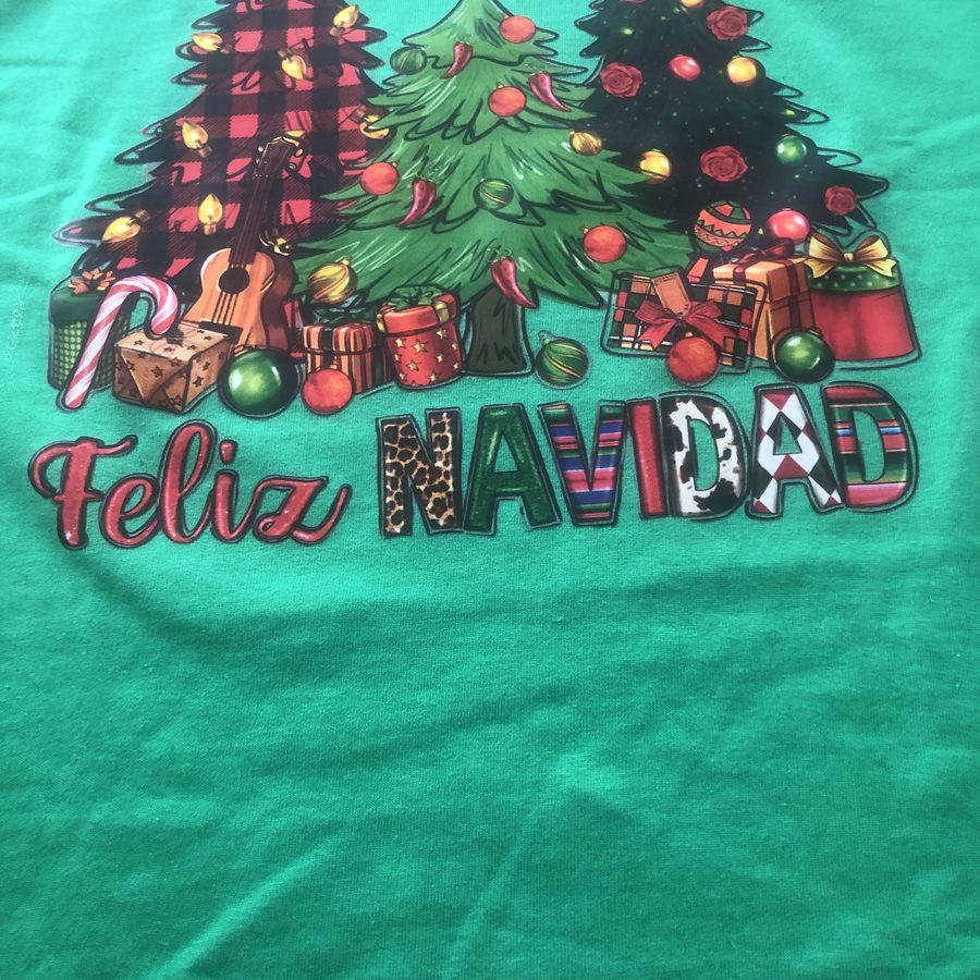 Green shirt printed with three Christmas trees and the words Feliz Navidad